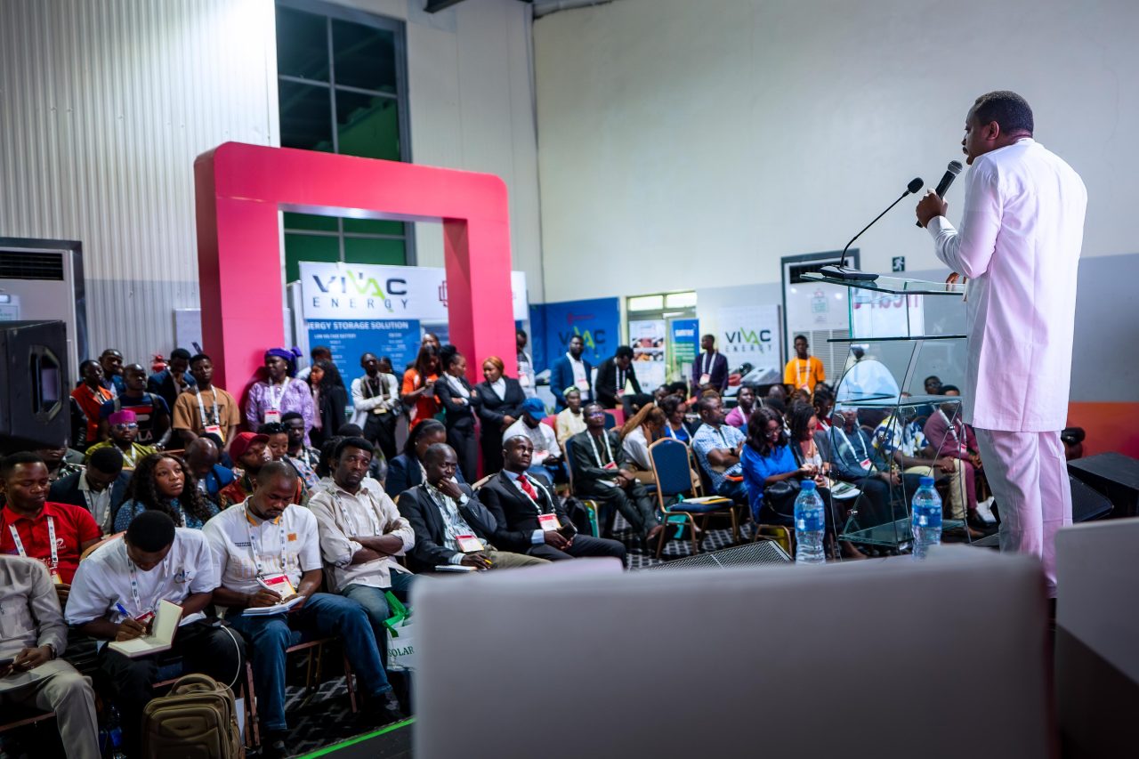 Exhibitor showcasing product to visitor