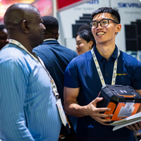 Exhibitor showcasing product to visitor